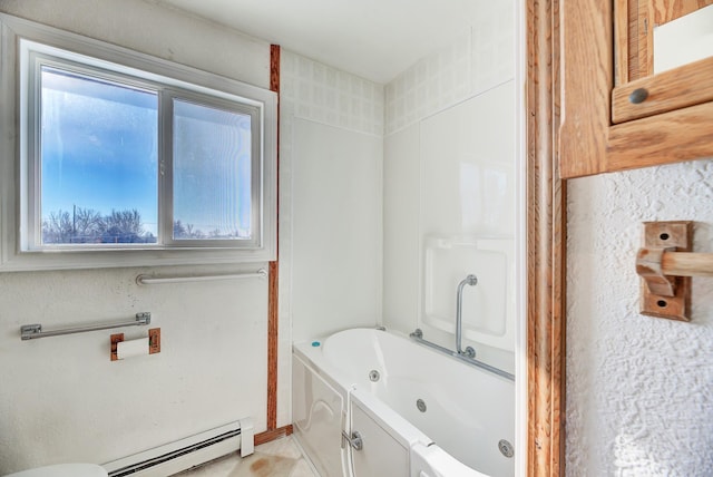 bathroom with baseboard heating and a bath