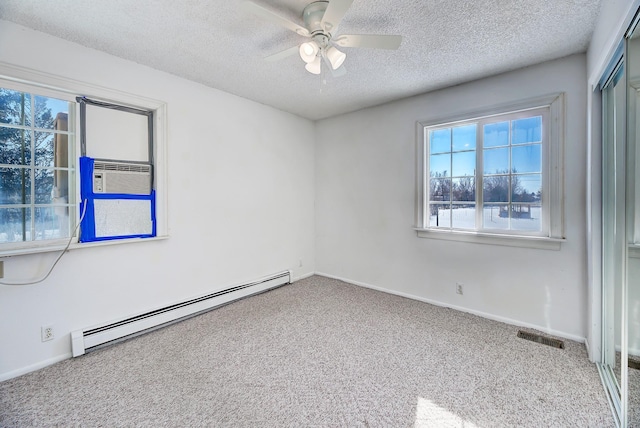 empty room featuring a textured ceiling, cooling unit, ceiling fan, carpet, and a baseboard heating unit