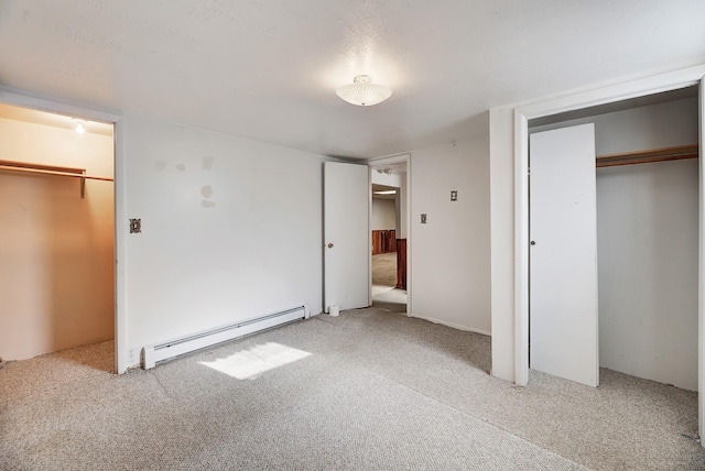 unfurnished bedroom with a baseboard radiator, light colored carpet, and a closet