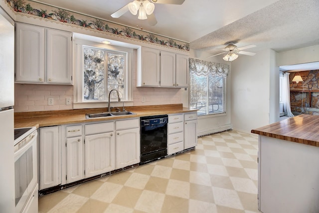 kitchen featuring butcher block countertops, black dishwasher, sink, white cabinets, and baseboard heating