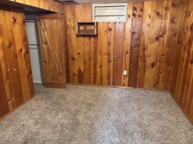 carpeted empty room with wooden walls