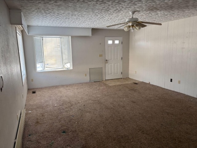 interior space featuring ceiling fan and carpet