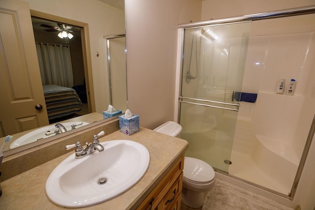 bathroom with vanity, an enclosed shower, and toilet