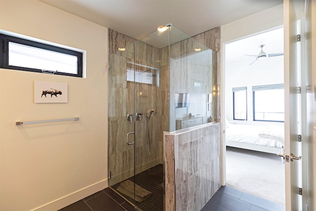 bathroom with a healthy amount of sunlight, ceiling fan, and a shower with door