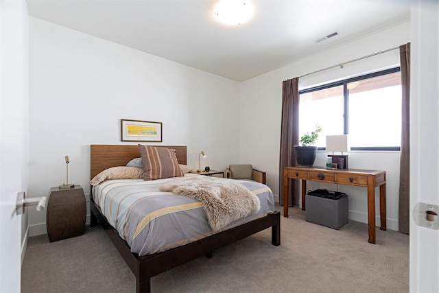 bedroom featuring light carpet and visible vents