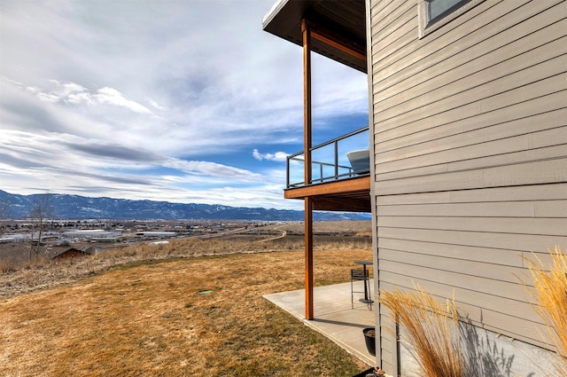 view of yard featuring a balcony and a mountain view
