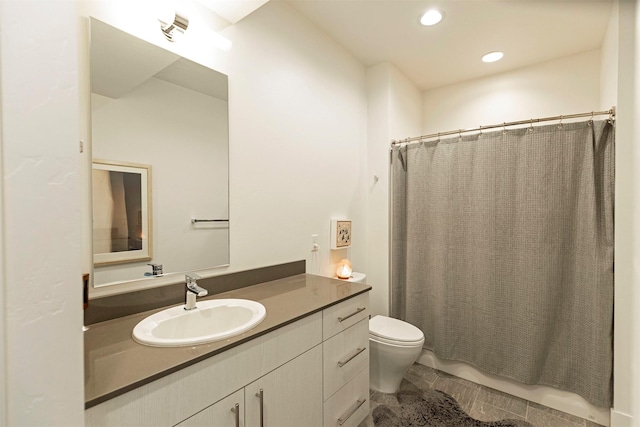 bathroom with toilet and vanity