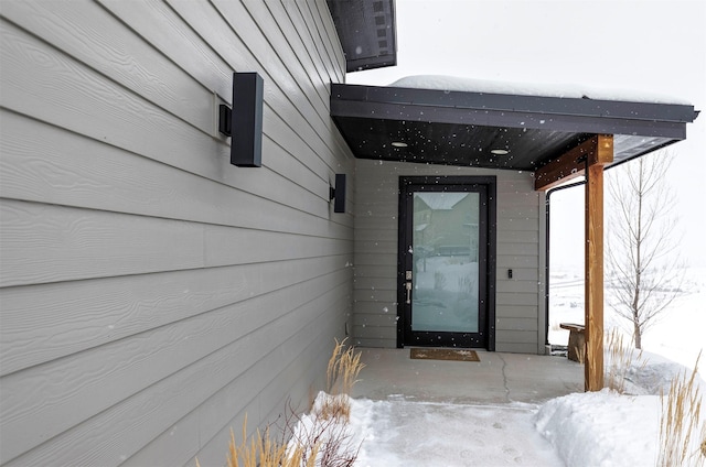 view of snow covered property entrance