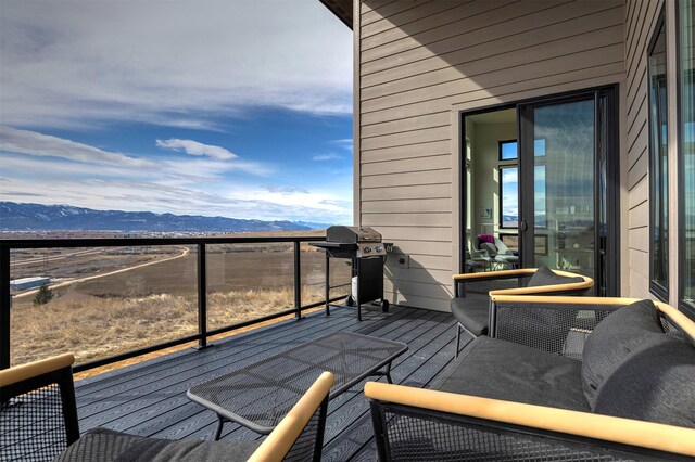 wooden terrace featuring grilling area and a mountain view