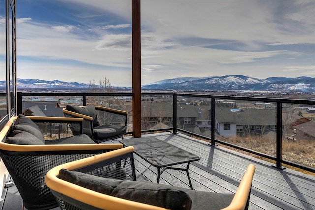 balcony featuring a mountain view and an outdoor living space