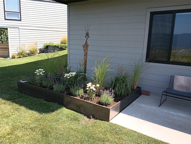 exterior space featuring a patio area and a lawn