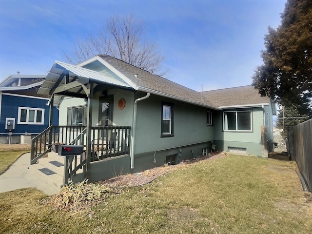 exterior space with fence, a porch, a front yard, stucco siding, and crawl space