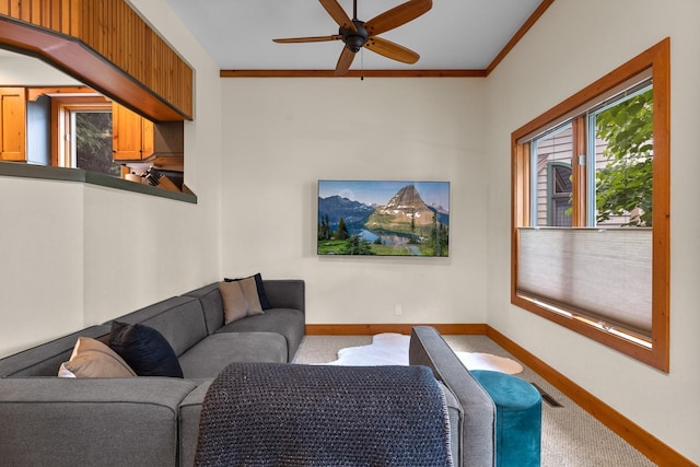 carpeted living room featuring ceiling fan and ornamental molding