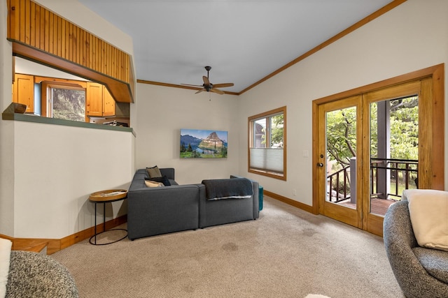 carpeted living room with a healthy amount of sunlight, ceiling fan, and ornamental molding