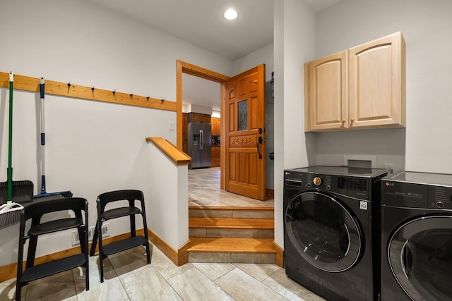 laundry room with independent washer and dryer and cabinets