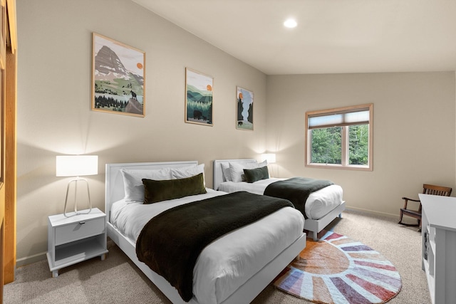 bedroom with vaulted ceiling and carpet flooring