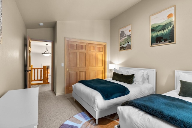 bedroom featuring light carpet, lofted ceiling, and a closet