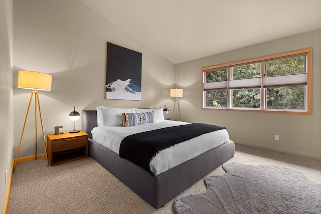 carpeted bedroom with vaulted ceiling