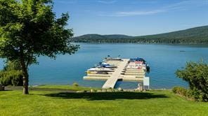 property view of water featuring a boat dock and a mountain view