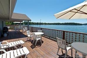 wooden terrace featuring a water view