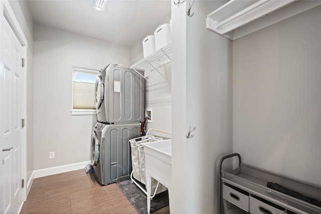 clothes washing area with stacked washer and clothes dryer