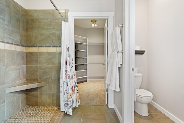 bathroom with toilet, tile patterned flooring, and a shower with curtain