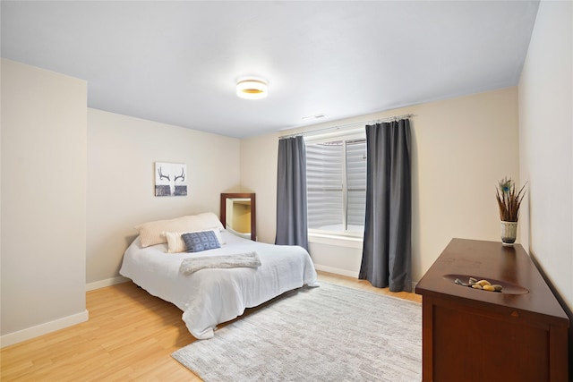 bedroom with hardwood / wood-style floors