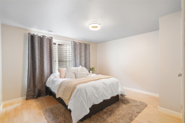 bedroom with light wood-type flooring