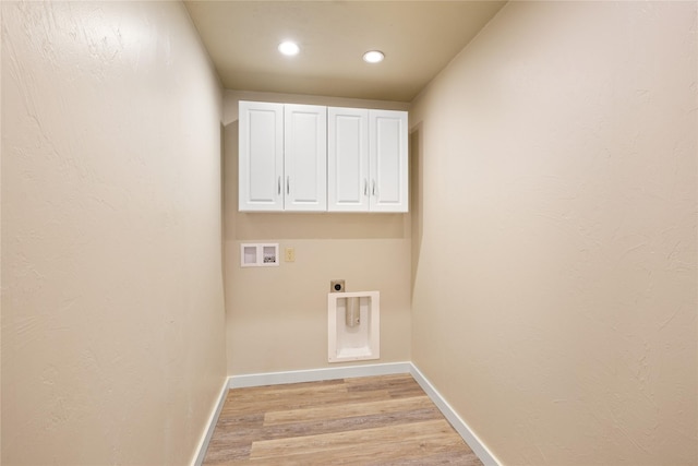 washroom with light wood-type flooring, cabinets, electric dryer hookup, and hookup for a washing machine