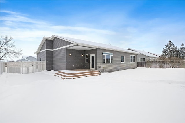 view of snow covered rear of property