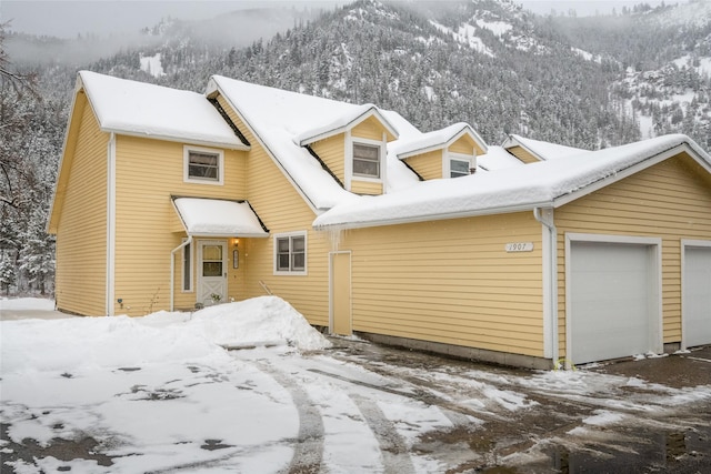 view of front of home featuring a garage and a mountain view