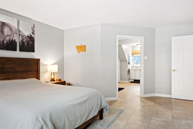 bedroom with light tile patterned floors and baseboards