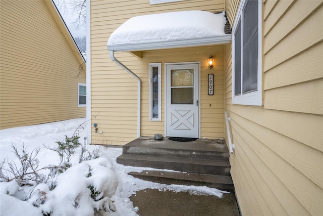 view of snow covered property entrance