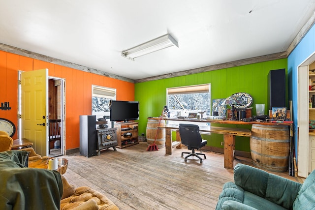 home office with plenty of natural light and light hardwood / wood-style flooring