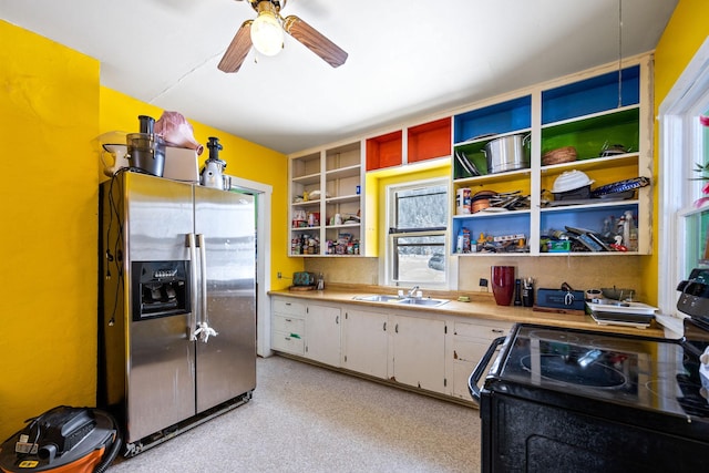 kitchen featuring sink, stainless steel fridge with ice dispenser, ceiling fan, black electric range oven, and white cabinets