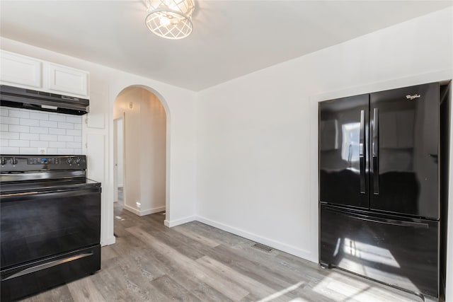 kitchen with light hardwood / wood-style floors, white cabinetry, black appliances, and decorative backsplash