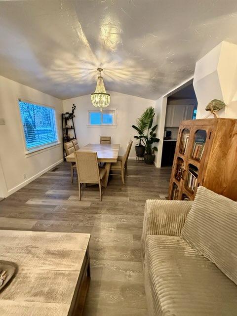 dining space featuring a chandelier and dark wood-type flooring