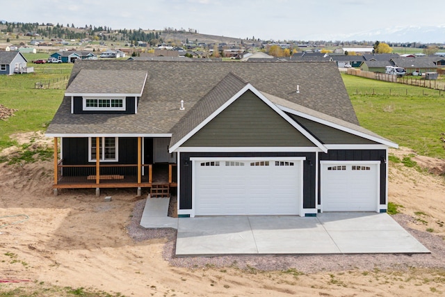 view of front of home featuring a garage and a porch