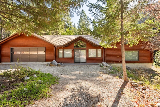 log-style house with a garage