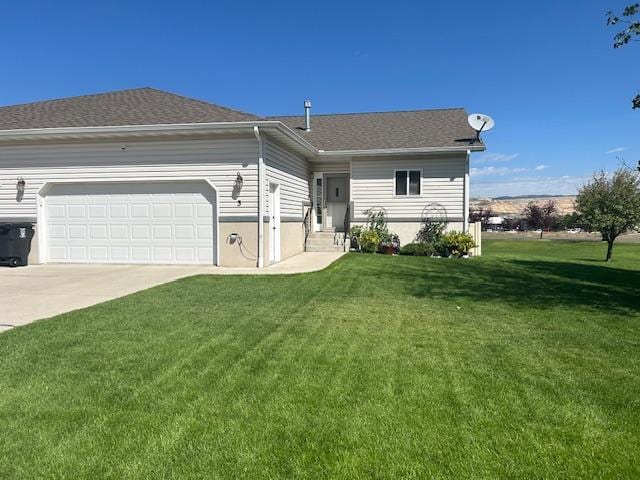 view of front of house featuring a garage and a front lawn