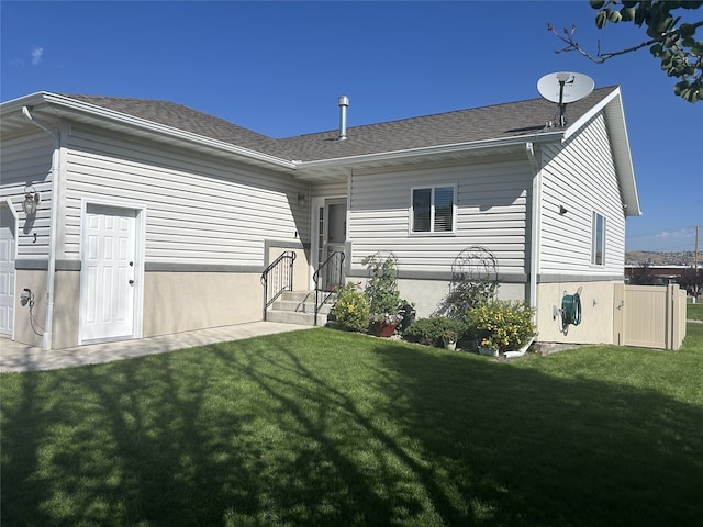 back of house with a lawn