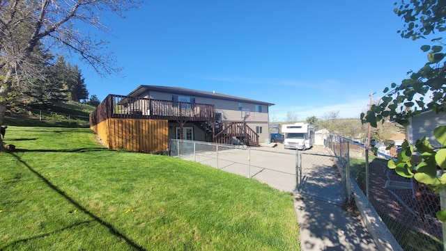 view of front of property featuring a deck and a front lawn