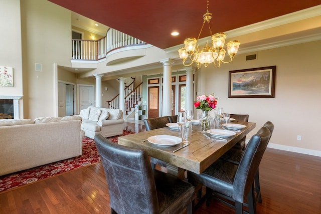 126 Soaring Eagle Dr, Whitefish, MT 59937 - dining space featuring visible vents, baseboards, dark wood-style floors, crown molding, and ornate columns
