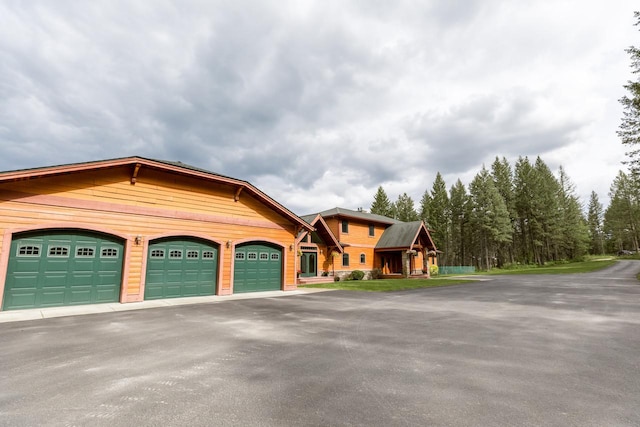 126 Soaring Eagle Dr, Whitefish, MT 59937 - view of front facade with an attached garage and aphalt driveway