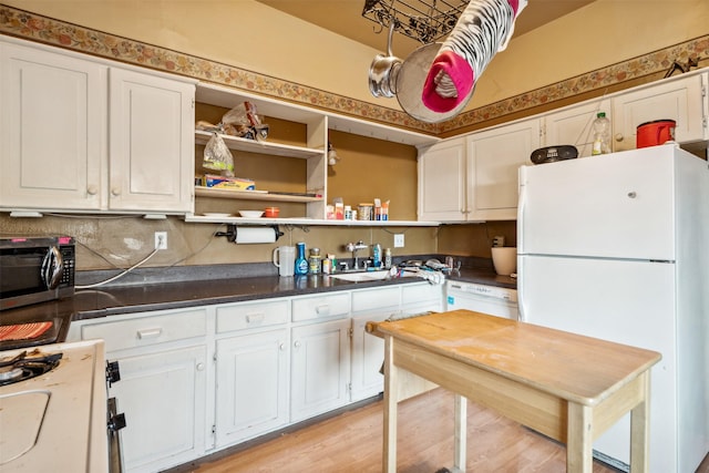 kitchen featuring decorative backsplash, white appliances, white cabinets, and light wood-type flooring