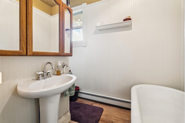 bathroom featuring a baseboard heating unit and hardwood / wood-style floors