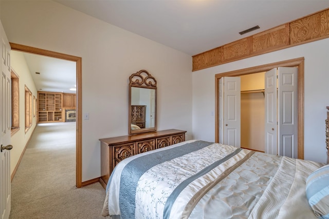 bedroom featuring a closet and light colored carpet