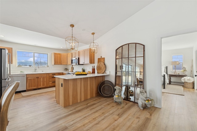 living area featuring a chandelier, light wood-type flooring, and lofted ceiling