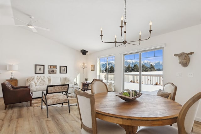211 Mcwenneger Dr, Kalispell, MT 59901 - dining area with a chandelier, light wood-style flooring, vaulted ceiling, and ceiling fan