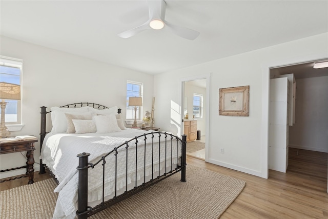 bedroom with baseboards, ceiling fan, connected bathroom, and light wood-style floors